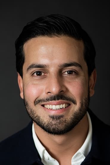 Professional headshot of Poyan Karimi