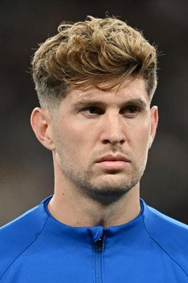 Professional headshot of John Stones