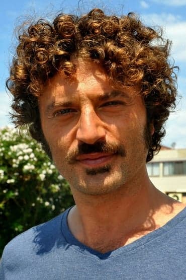 Professional headshot of Guido Caprino